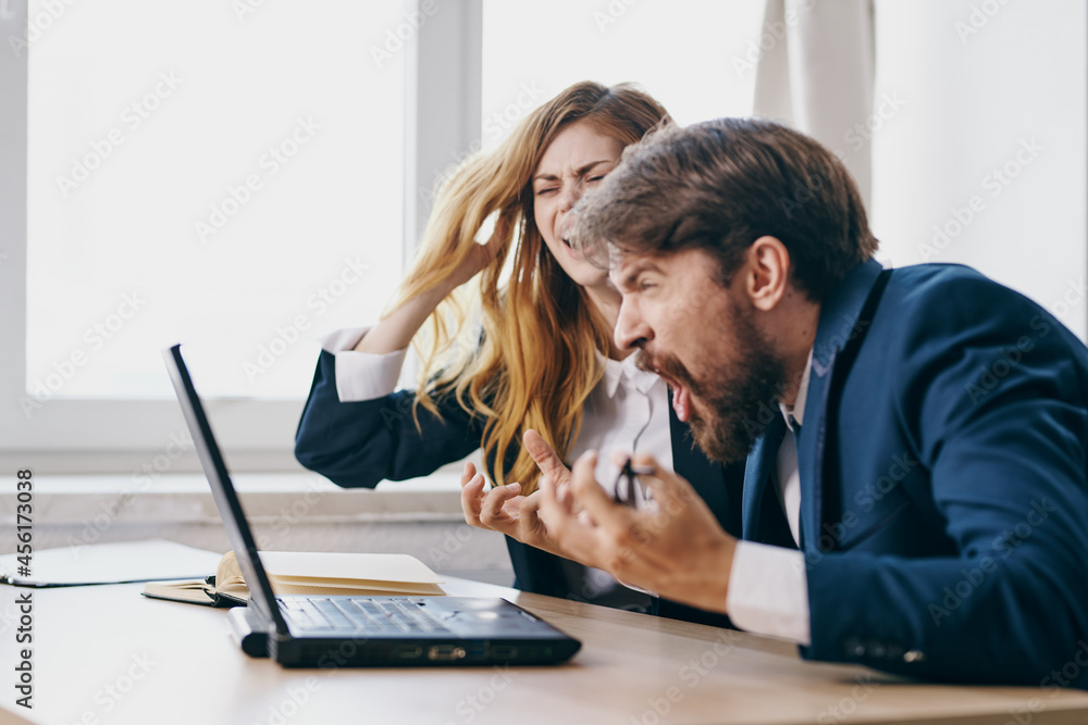 business man and woman sitting in front of a laptop teamwork professionals business man and woman sitting in front of a laptop teamwork professionals