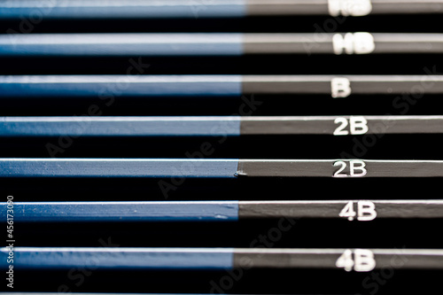 Full set of black and blue pencils sorting from dark to light.