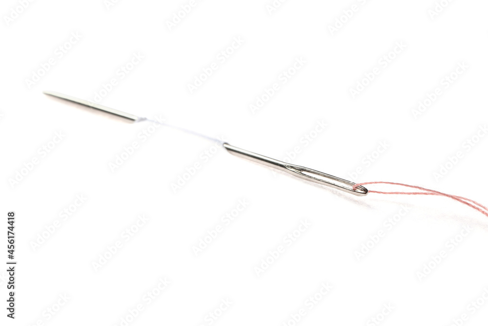 Sewing needle with thread piercing white paper
