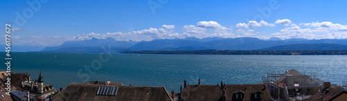 Beautiful wide angle view over the old town of Nyon with Lake Geneva and European Alps in the background on a sunny summer day. Photo taken August 28th, 2021, Nyon, Switzerland. photo