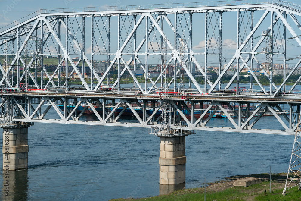 Arch of a railway bridge over a river in an industrial city. Arch of a railway bridge over a river in an industrial city.