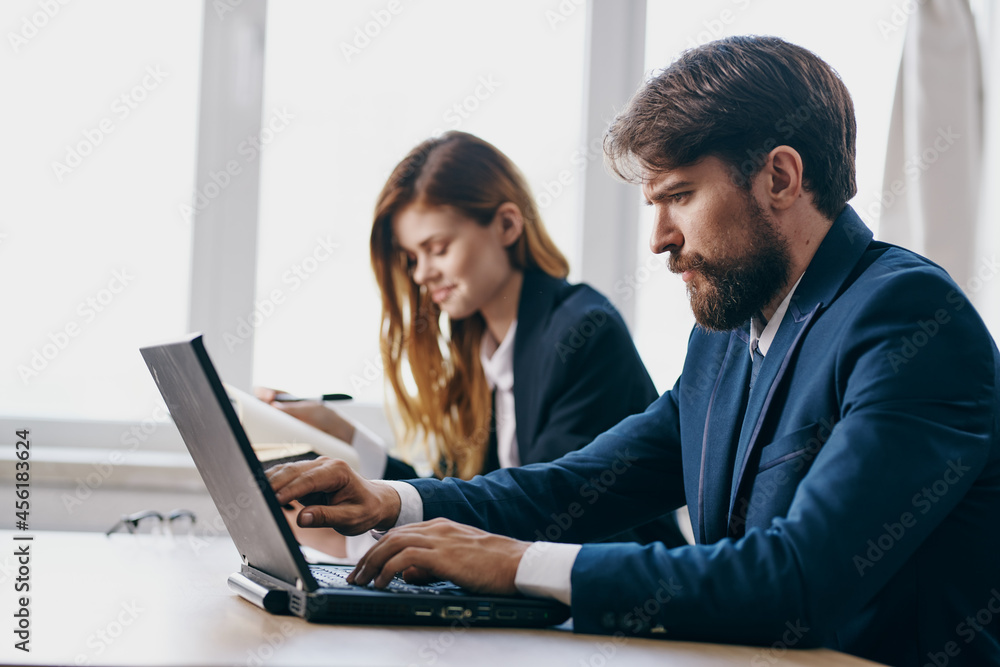 managers sitting in front of a laptop teamwork internet professionals managers sitting in front of a laptop teamwork internet professionals