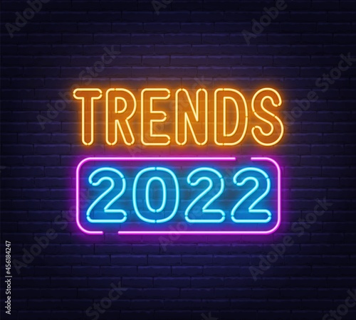 Trends 2022 neon sign on brick wall background. photo