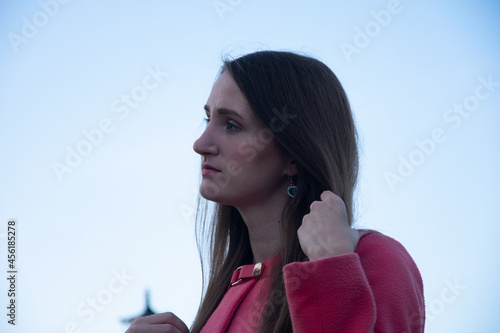 Thoughtful woman fixing hair in park