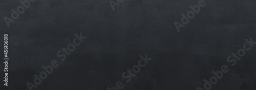 A real machine painted soft wall in black made of concrete with soft texture, good for any sport or fashion backgrounds where intensive colors can be used.