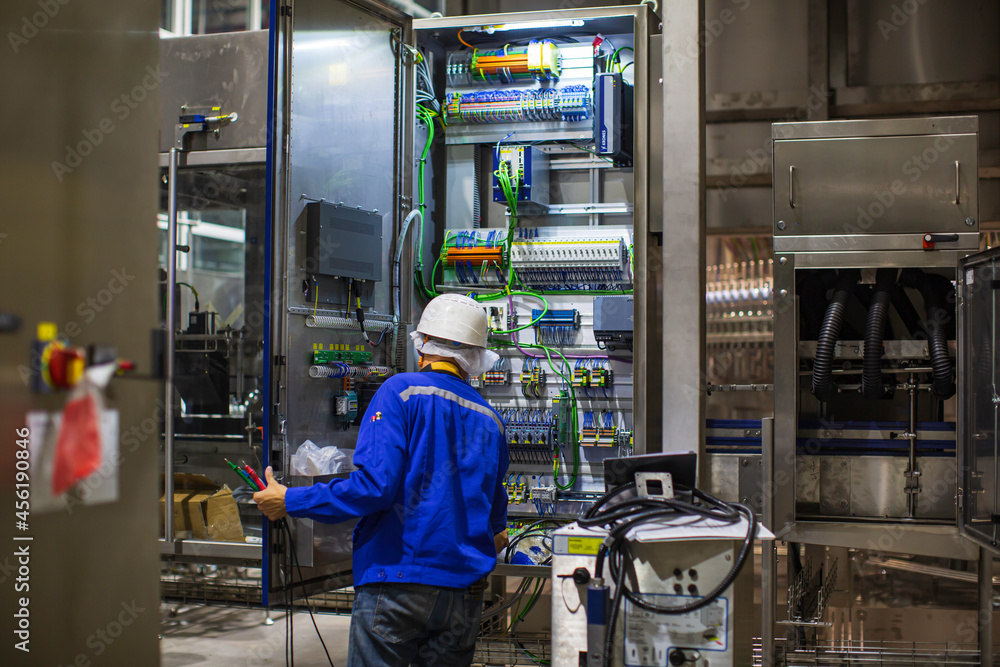 Electrician engineer tests electrical box control Electrician engineer tests electrical box control