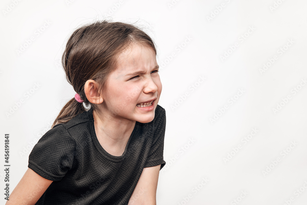 Upset child in aggression. The child screams. The girl is unhappy and in a bad mood. Upset child in aggression. The child screams. The girl is unhappy and in a bad mood.