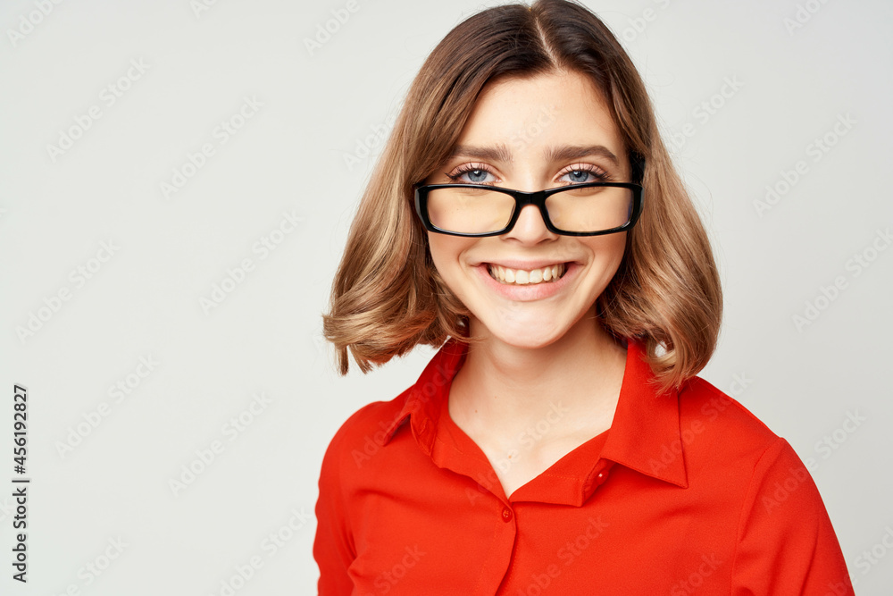 cheerful business woman in a red shirt wearing glasses manager work