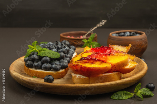 Tasty toast bread with cream cheese and ripe fruits