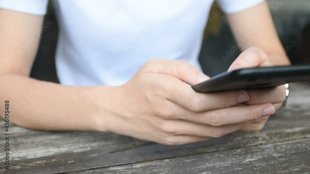 Closeup hand using smartphone, Hand holding mobile phone Closeup hand using smartphone, Hand holding mobile phone