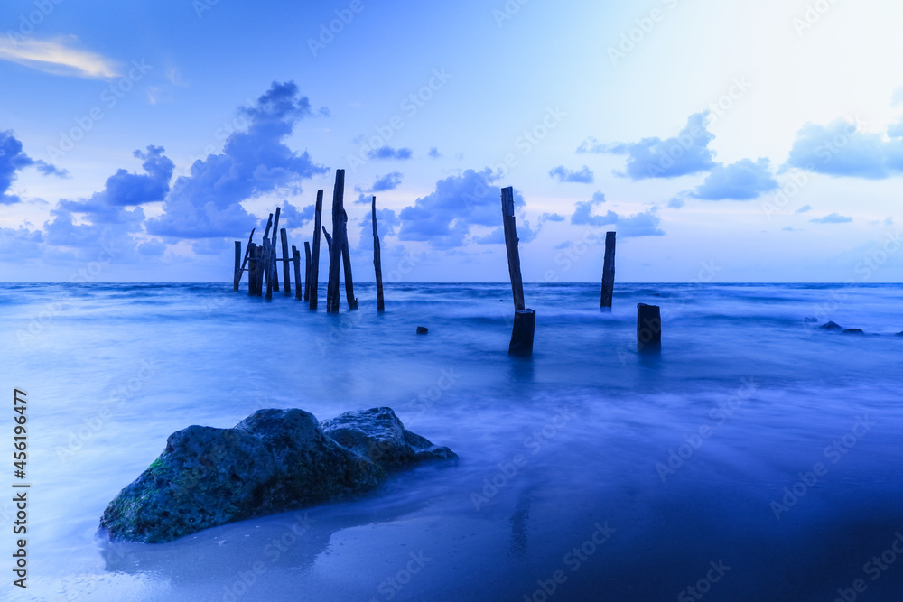Old wooden bridge abandoned pier stumps at Thungsang bay in Chomphon province Thailand, Tropical beach seaside, White Balance effect