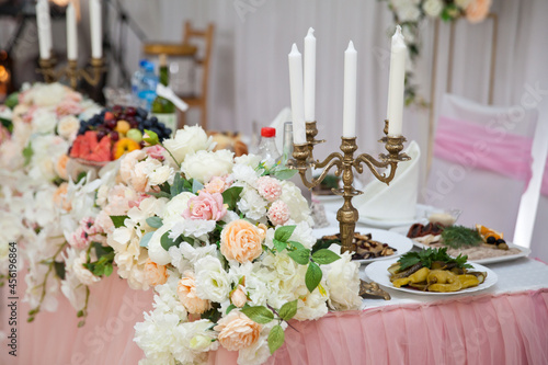 Antique candlestick with wedding bouquet.wedding candlestick with flower decoration before wedding ceremony.