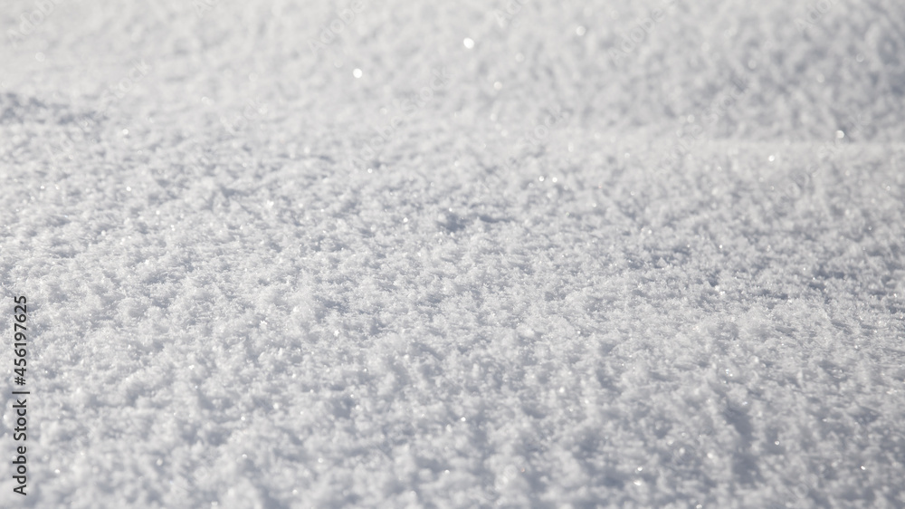 Smooth surface of clean fresh snow. Snowy ground. Winter background with snow patterns. Natural snow texture.
