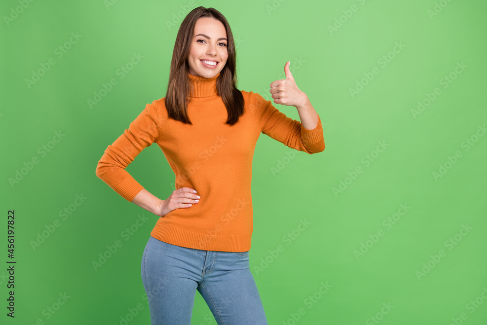 Portrait of attractive cheerful girl showing thumbup ad advert recommend decision isolated over green color background Portrait of attractive cheerful girl showing thumbup ad advert recommend decision isolated over green color background