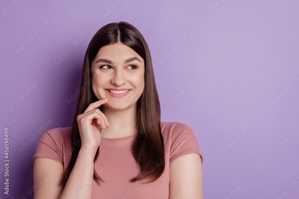 Close up photo of nice attractive girl happy positive smile finger touch chin look empty space isolated over violet color background Close up photo of nice attractive girl happy positive smile finger touch chin look empty space isolated over violet color background