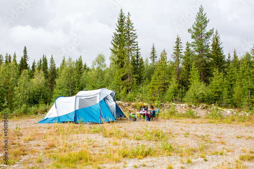Happy family with three kids, wild camping in Norway summertime