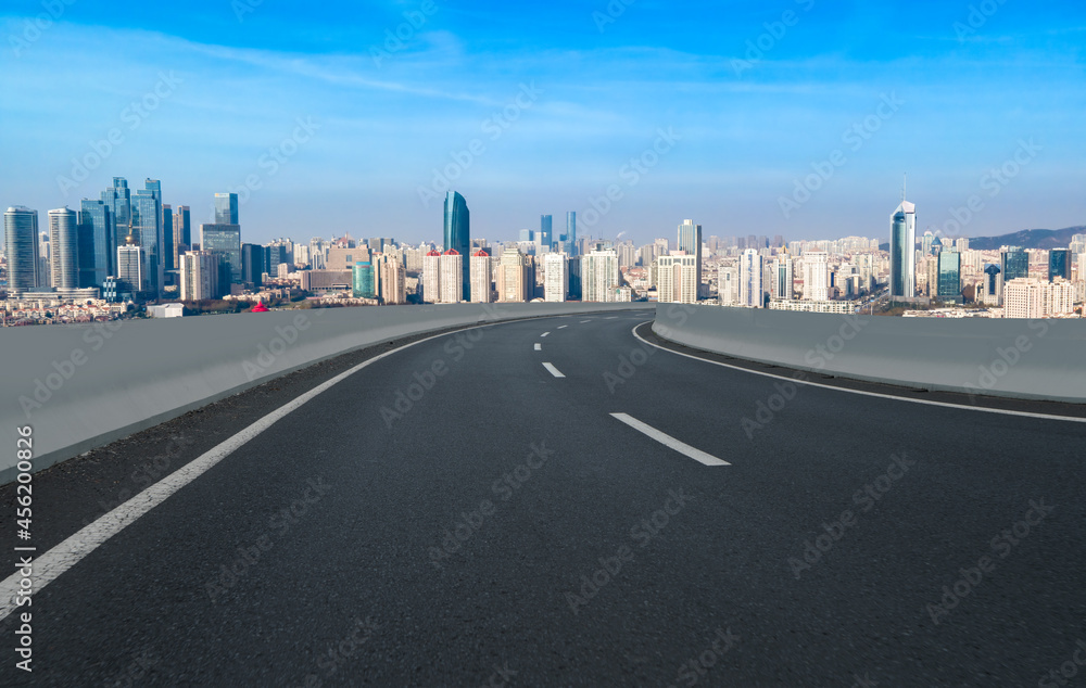 Fototapeta premium Road and city buildings background
