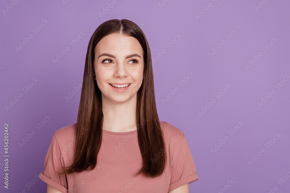 Portrait of yong woman smile look empty space over violet background Portrait of yong woman smile look empty space over violet background