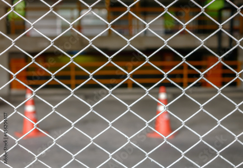 Steel metal fence with traffic cone background