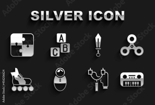 Set Tumbler doll toy, Fidget spinner, Toy piano, Slingshot, Roller skate, Sword, Puzzle pieces and ABC blocks icon. Vector