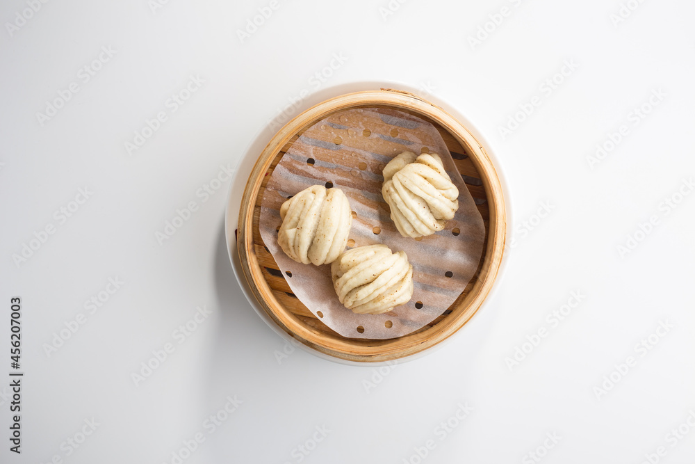 Chinese steamed buns Baozi in basket isolated on white background