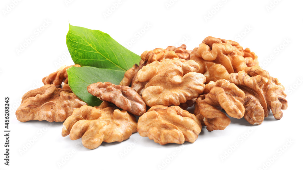 Pile of peeled walnuts and leaves on white background Pile of peeled walnuts and leaves on white background