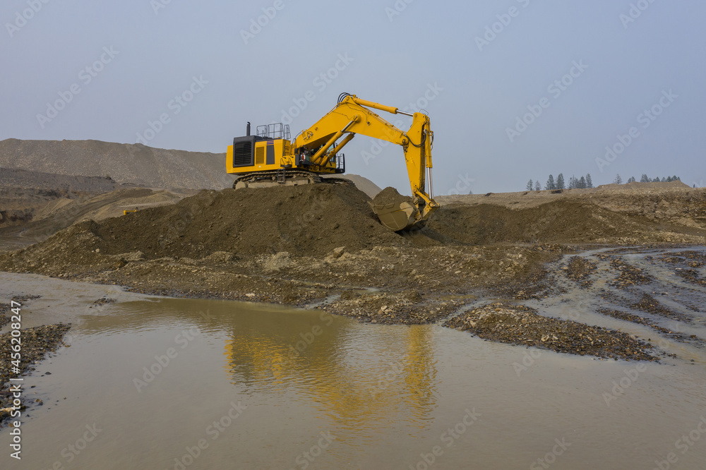 An excavator works in an open-pit gold mine.
