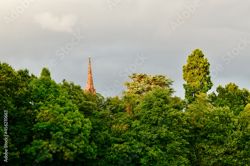 Landscape with a medieval church spire behind trees, Coventry, England, UK