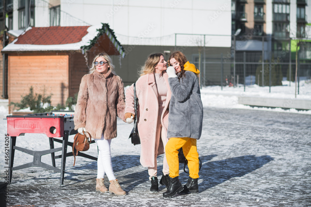 Three beautiful Russian girls are having fun on the street