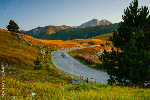 Corno Grande view from Campo Imperatore over a country road at the sunrise in Abruzzo, Gran Sasso National Park, Italy