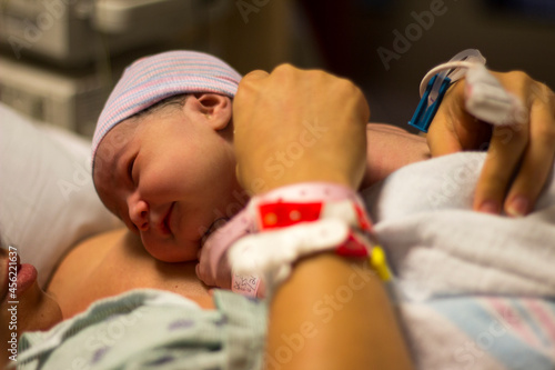 Laid directly on the mother's bare chest after birth, Skin to skin