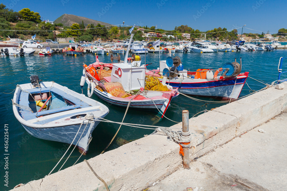Colorful traditional fishing boats are moored in port