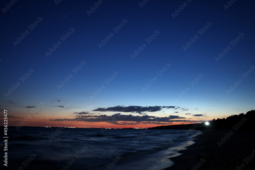 Fototapeta premium Picturesque view of beautiful sunset on seaside at night