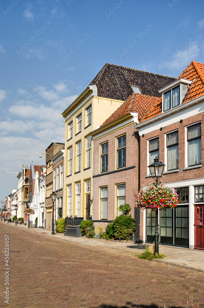 Zwolle, The Netherlands, August 4, 2021: row of historic houses with colorful brick and plaster facades along downtwon Thorbecke canal