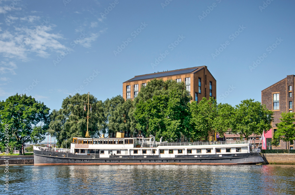 Zwolle, The Netherlands, August 15, 2021: historic ferry Oosterschelde, now used as a party boat, moored in the city canal on a sunny day in summer Zwolle, The Netherlands, August 15, 2021: historic ferry Oosterschelde, now used as a party boat, moored in the city canal on a sunny day in summer
