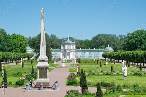 Moscow, Russia - June 17, 2021: Obelisk in honor of Catherine II and a large stone greenhouse in the Kuskovo Estate 