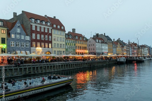 Copenhague, Denmark. September 28, 2019: Nyhavn promenade with colorful architecture and boats on the canal.