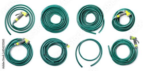 Set with green rubber watering hoses on white background, top view. Banner design photo