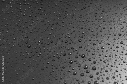 drops of water on a black background. texture. dew on the surface. moistening. drops after rain or fog.