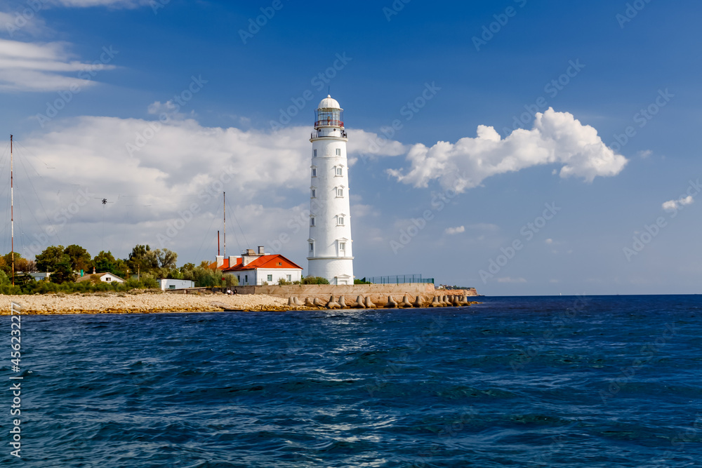Lighthouse at Cape Chersonese. Sevastopol, Crimea, Russia. Cloudy sunny day.