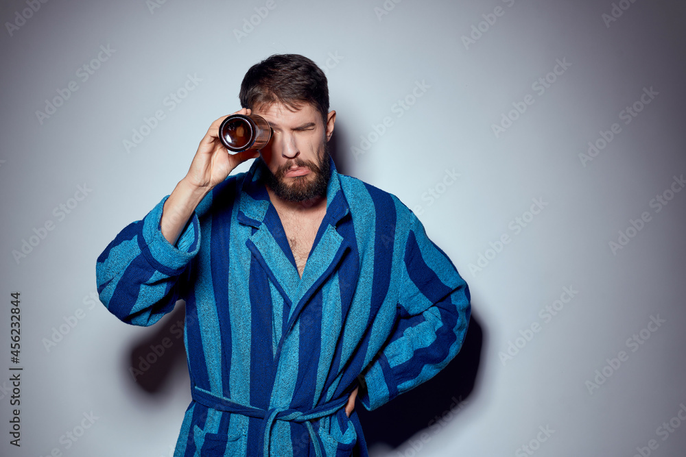 man in blue robe beer bottle rest at home man in blue robe beer bottle rest at home