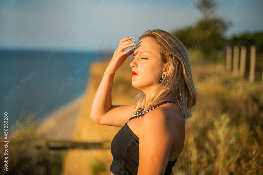 Fashion woman. Cute teenage girl or woman on the beach nature landscape fresh air beach. Natural beauty. lifestyle, real people. Bright make up, red lips. Fashion woman. Cute teenage girl or woman on the beach nature landscape fresh air beach. Natural beauty. lifestyle, real people. Bright make up, red lips.