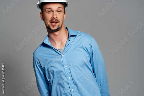 male builder in a blue shirt work emotions isolated background