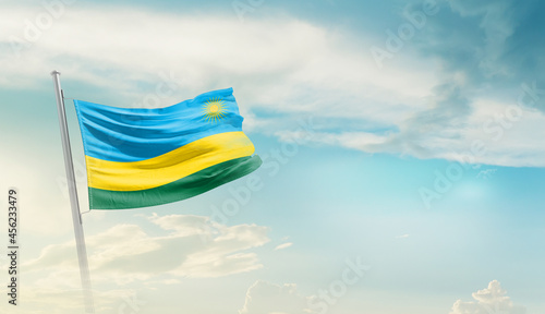 Rwanda national flag cloth fabric waving on the sky - Image photo