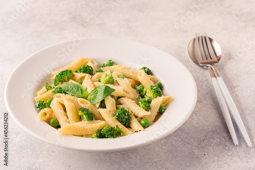 Pasta with green peas, broccoli and parmesan cheese.