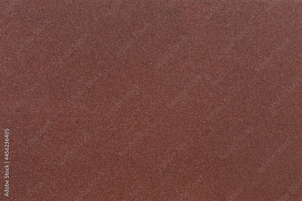 Red-brown sandpaper texture. Rough sandpaper background. Copy space. Red-brown sandpaper texture. Rough sandpaper background. Copy space.