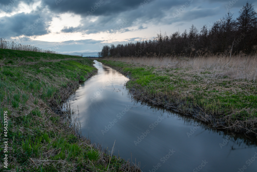 Uherka river in eastern Poland and cloudy sky