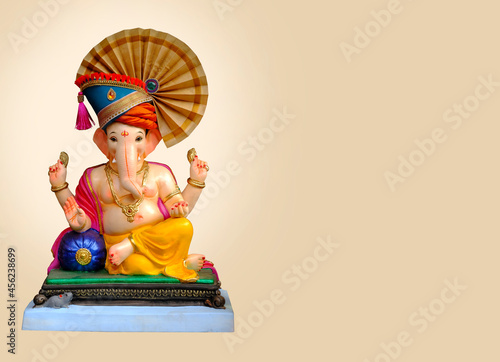 Hindu God Ganesha on colorful background, with copy space, Ganesha is the patron of arts and sciences