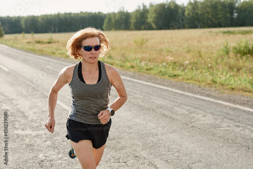 Female athlete running on a road she preparing for her competition