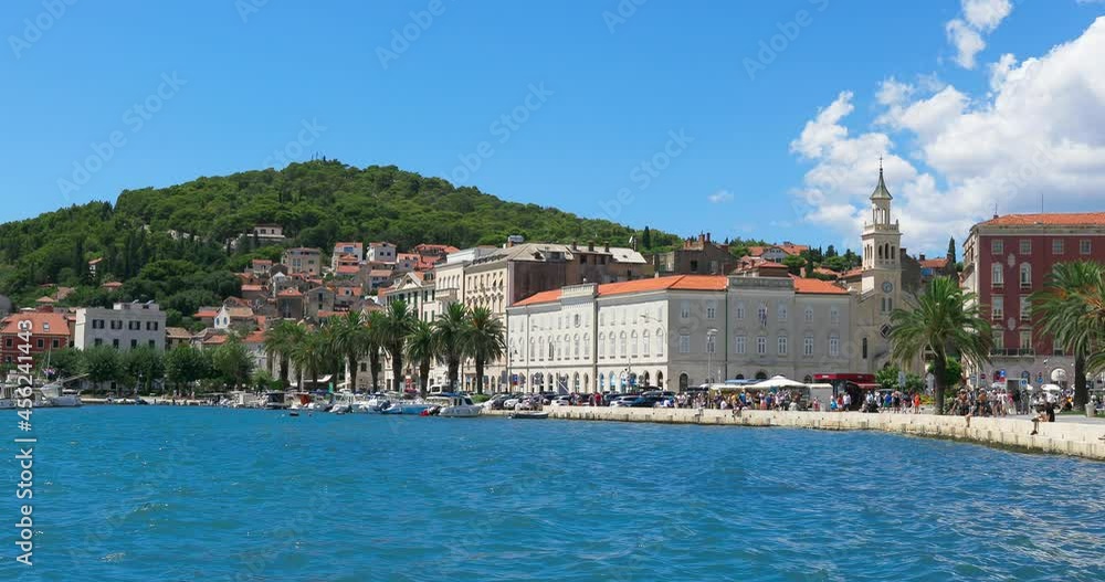 People walking along the waterfront in Split on a sunny summer day, Croatia. People walking along the waterfront in Split on a sunny summer day, Croatia.